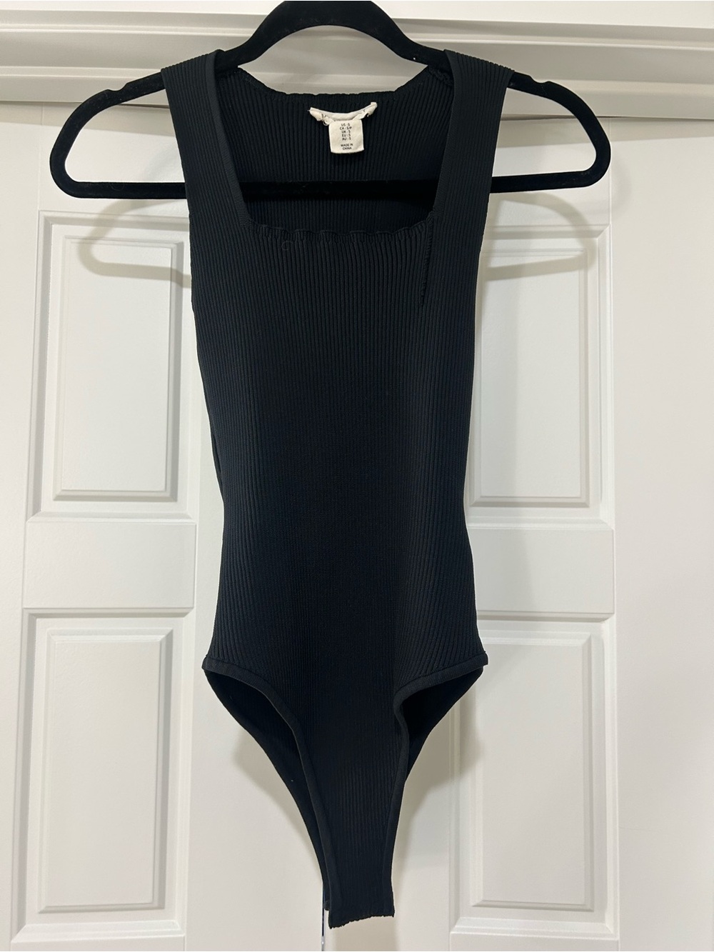 Black Ribbed One-Piece Sleeveless Bodysuit